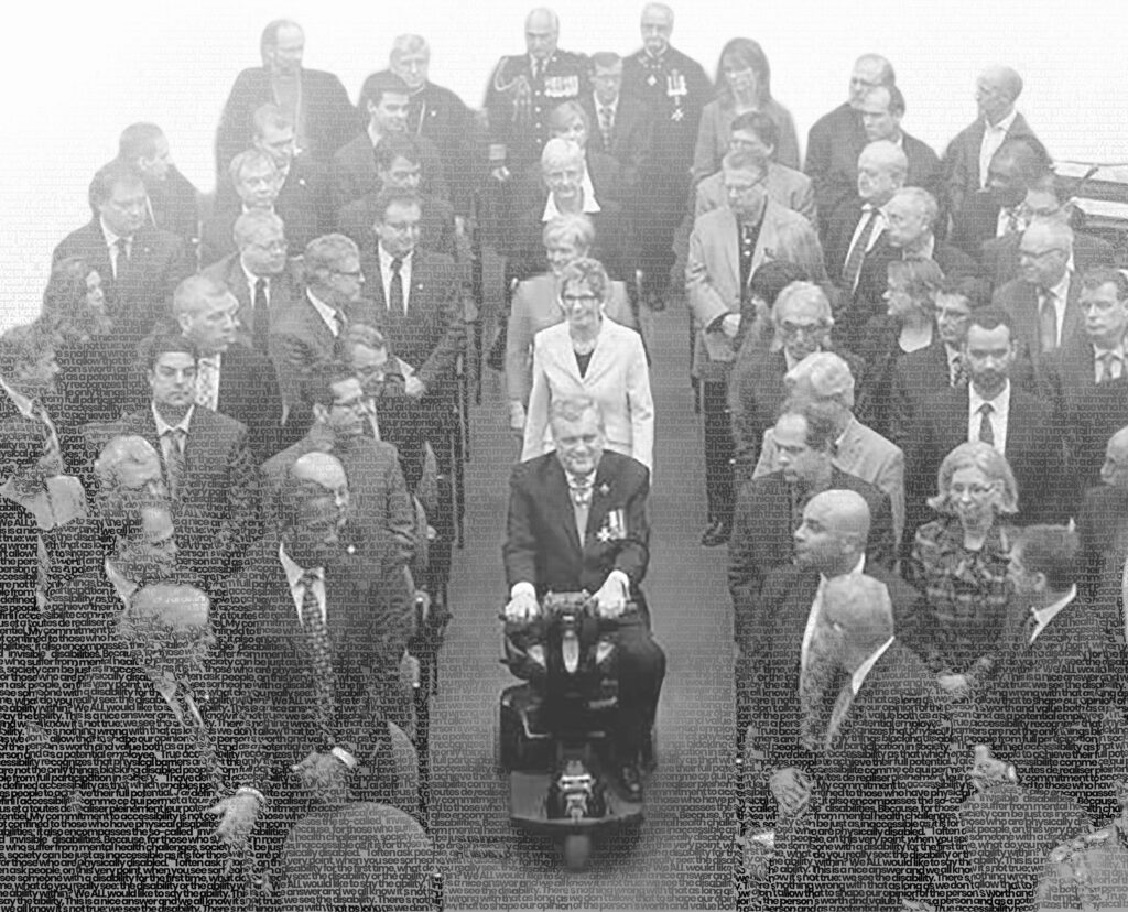 Black and white image of David Onley entering a room full of people.